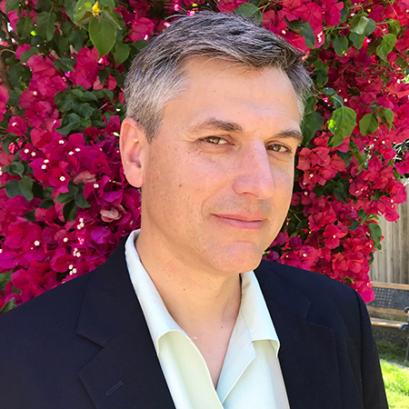 A photo of Addison Snell in front of flowering bush