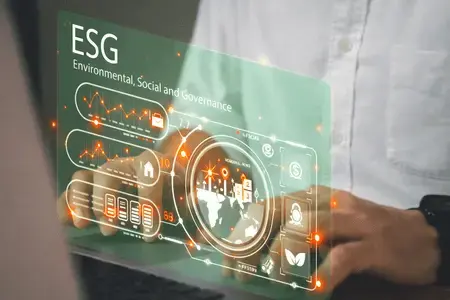 Glow-in-the-dark digital 'ESG' icon and leaf symbols held in a hand, representing sustainable IT energy management