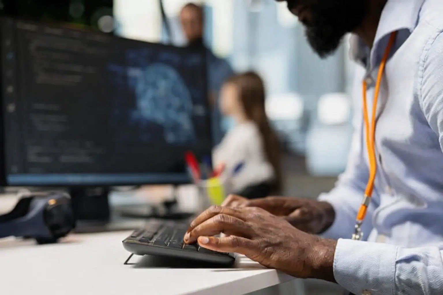 african_american_typing_orange_lanyard